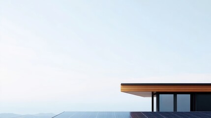 Modern house rooftop with solar panels against a clear sky.
