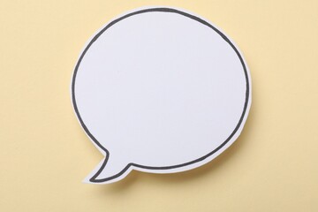 Blank speech bubble on beige background. Space for text
