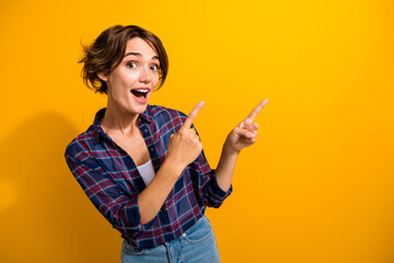 Photo of overjoyed woman with bob hair dressed plaid shirt indicating at unbelievable sale empty...