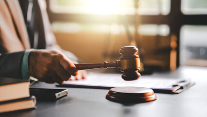 Close-up focuses on judge's hammer on lawyer's table Male consultant or lawyer working in the office Legal concepts, advice