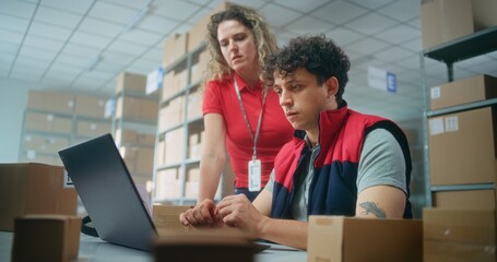 Team of warehouse associates or inventory managers talk, prepare parcels for shipping to customers, check information on laptop computer, work in post office. Logistics center or delivery service.