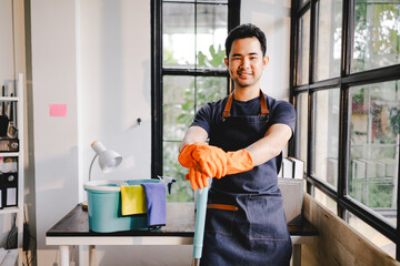 male cleaning staff Hold wipes and a bottle of disinfectant spray. and cleaning equipment