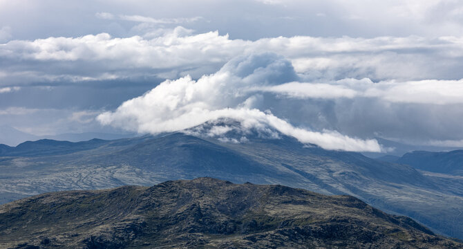Radio-tower on Bl&aring;h&oslash;e partly covered by clouds -  seen from Formokampen in the Rondane national park