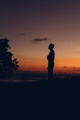 Unrecognizable silhouette of woman in twilight