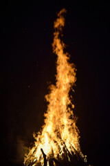 Majestic Bonfire Blazing Against Dark Night Sky with Flames Rising