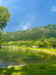 Serene Lake Idro Surrounded by Majestic Mountains and Cloudy sky, Italy, Crone