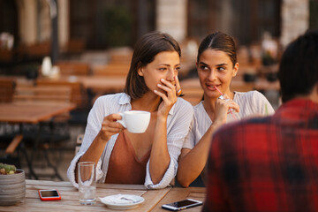 Beautiful girls drinking coffee and talking