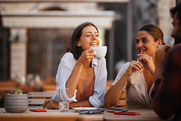 Beautiful girls drinking coffee and talking
