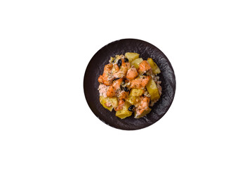 Baked salmon pieces with potatoes, cheese and olives