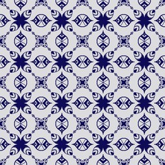 Seamless pattern with blue floral and leaf motifs in a symmetrical tile arrangement on a light gray background, perfect for decor.