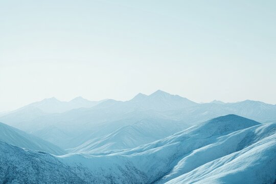 Serene winter landscape showcasing snow-covered mountains under a bright, clear sky.