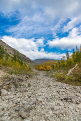 View to Khibiny mountains near Mannepakhp river. Early autumn in arctic tundra region. Kola peninsula, Murmansk region, Russia.