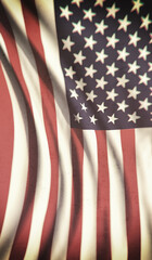 The waving American flag, a patriotic symbol of the United States, displays its iconic stars and stripes of red, white, and blue