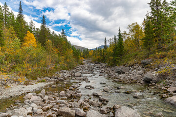 Fototapeta premium View to Mannepakhp river at Khibiny mountains. Early autumn in arctic tundra region. Kola peninsula, Murmansk region, Russia.