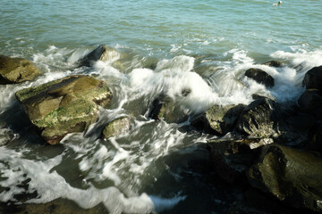Strong splashes of the sea. strong wave crashed into the rocks and strong drops of water in the air.