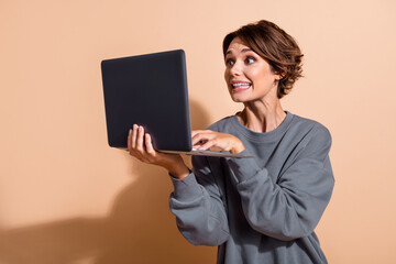 Photo of ecstatic eccentric funny woman dressed grey pullover play excited video game on laptop...