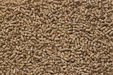 Wood filler for cat toilet, top view. Hygienic filler for pets. Pressed wood, large granules....