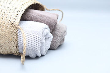 Closeup natural cotton towels in bamboo basket.Stylish interior  eco design with copy space.
