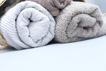 Stack of towels on grey background with copyspace.