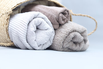 Closeup natural cotton towels on grey background with copyspace.