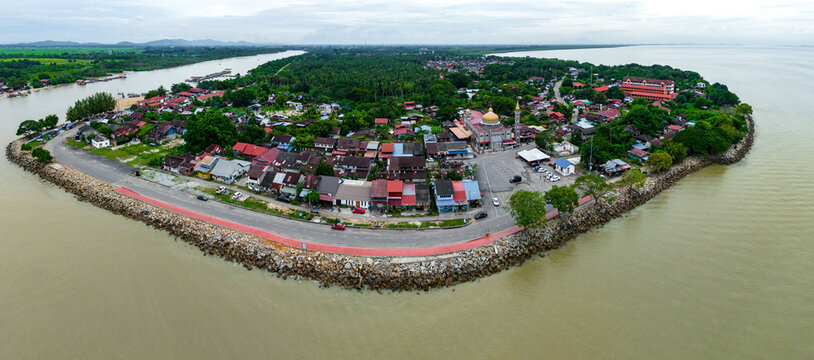 Aerial drone view of serene fisherman town near river estuary scenery at Pantai Kuala Muda, Penaga, Pulau Pinang, Malaysia.