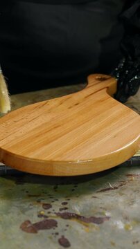 Brushing Varnish onto a Wooden Piece in a Workshop