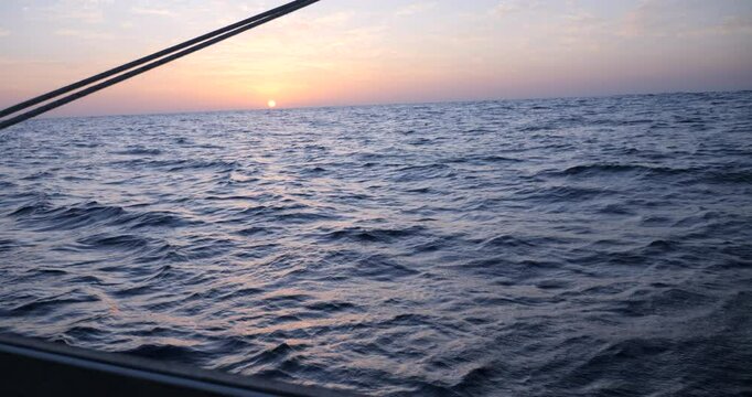 Sunset seen from a sailboat over the bay of Biscay in the Atlantic Ocean