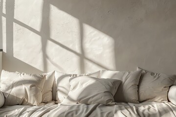 Soft sunlight streaming through a window casts delicate shadows on a cozy white sofa adorned with plump cushions and a light blanket