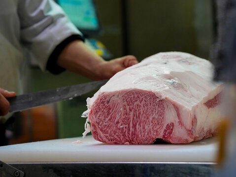 butcher cutting meat