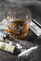 White drugs, narcotic pills, an alcoholic drink in a glass, a syringe with a dose of heroin, a line...
