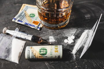 White drugs, narcotic pills, an alcoholic drink in a glass, a syringe with a dose of heroin, a line...