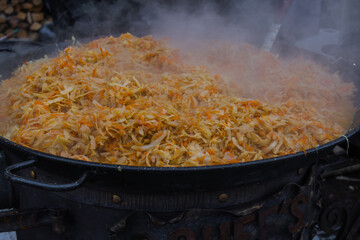 Bigus, stewed cabbage in a cauldron at a street fair, street food