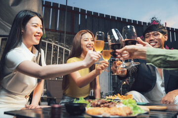 Nighttime Cheers: Friends Toast to Friendship and Fun at a Backyard Gathering 