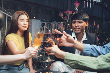 Cheers to Friendship: A group of friends raise their glasses in a toast, their smiles and laughter illuminating the warm ambiance of a cozy gathering.
