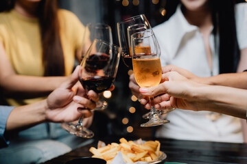 Cheers to Friendship: Hands clinking glasses in a toast, symbolizing camaraderie and shared moments.