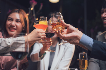 Cheers to Success:  A group of friends raise their glasses in a toast, celebrating their accomplishments.