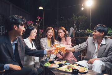 Nighttime Cheers: A group of friends toasts to good times and company, their laughter echoing through the night. The warm glow of the lights creates a cozy atmosphere.