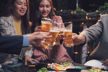 Cheers to Friendship: A group of friends raise their beer glasses in a celebratory toast, enjoying a relaxed evening together.