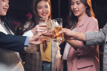 Cheers to Success: A group of stylish young professionals raise their glasses in a celebratory toast, their smiles reflecting camaraderie and achievement.