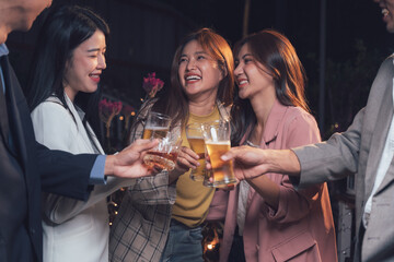 Nighttime Celebration: Cheers to Success! Friends raise a toast, celebrating achievements with laughter and shared joy under the warm glow of night.  