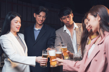 Cheers to Success: A group of young professionals raise their glasses in a toast, celebrating their achievements in a warm and intimate setting. This image evokes a sense of camaraderie.