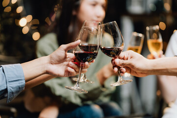 Cheers to Connection:  Close-up shot of hands clinking wine glasses, capturing the warmth and camaraderie of a celebratory moment between friends.  