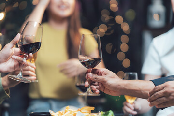 Cheers to Friendship: A heartwarming close-up captures hands raising wine glasses in a toast, symbolizing camaraderie and shared moments. The bokeh background hints at a lively gathering.