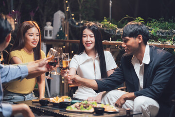 Nighttime Cheers: Friends Toast Success at Outdoor Gathering 