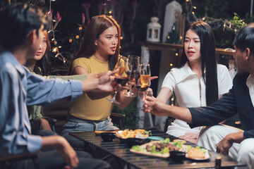Cheers to Friendship: A group of friends raise their glasses in a toast, surrounded by delicious food and warm lighting, capturing the essence of camaraderie and celebration.  
