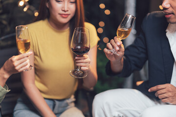 Nightlife Cheers: Friends raise a toast, sharing wine and laughter under warm string lights. A moment of casual elegance and connection. 