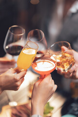 Cheers to Friendship: A toast to togetherness—four hands raise glasses filled with vibrant drinks, symbolizing camaraderie and celebration.  