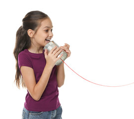 Girl using tin can telephone on white background
