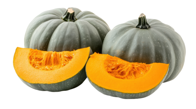 Autumn harvest featuring freshly cut gray pumpkins with bright orange flesh on wooden table