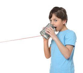 Boy using tin can telephone on white background
